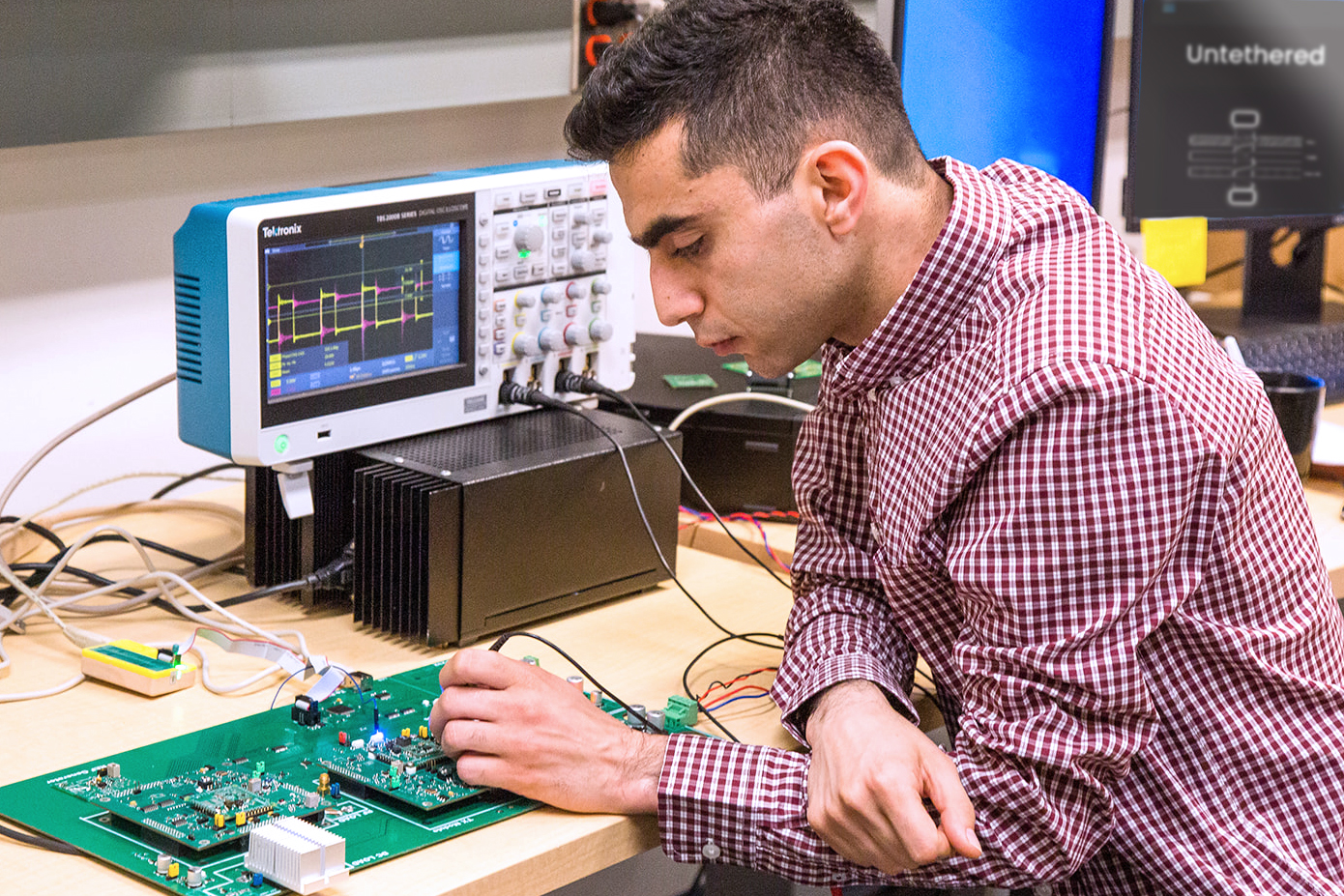 Daanaa's electrical engineering team working on a circuit board.